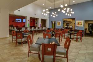 um restaurante com mesas e cadeiras e um bar em Hampton Inn Tropicana em Las Vegas