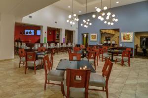 a restaurant with tables and chairs and a bar at Hampton Inn Tropicana in Las Vegas