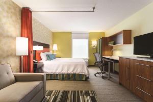 a hotel room with a bed and a desk at Home2Suites Pittsburgh Cranberry in Cranberry Township