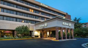 a hotel building with a parking lot in front of it at Hilton Washington DC/Rockville Hotel & Executive Meeting Center in Rockville