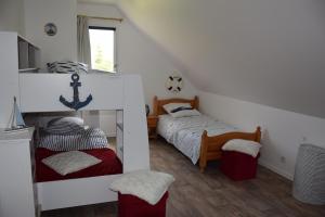 a small bedroom with two beds and a window at Baie du Mont Saint Michel, optez pour notre "Plan Baie" in Saint-Jean-le-Thomas