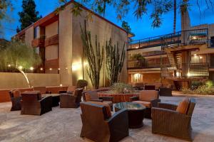 a patio with chairs and tables in front of a building at DoubleTree by Hilton Phoenix- Tempe in Tempe