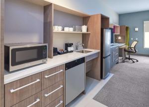 a kitchen with a sink and a microwave at Home2 Suites By Hilton Ft. Lauderdale Downtown, Fl in Fort Lauderdale