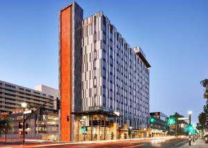 a rendering of a tall building on a city street at Canopy By Hilton Tempe Downtown in Tempe