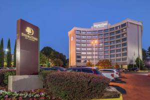 a hotel with cars parked in front of a parking lot at DoubleTree by Hilton Atlanta North Druid Hills/Emory Area in Atlanta