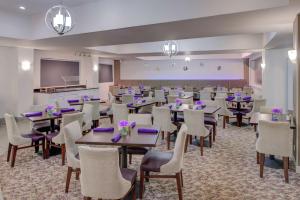 a conference room with tables and chairs and a screen at DoubleTree by Hilton Atlanta North Druid Hills/Emory Area in Atlanta