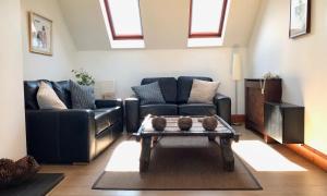 a living room with two couches and a coffee table at Home with superb view of St Andrews in St Andrews