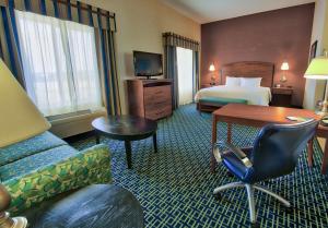 a hotel room with a bedroom with a bed and a desk at Hampton Inn & Suites Ridgecrest in Ridgecrest