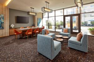 um átrio com cadeiras, uma mesa e uma televisão em Homewood Suites by Hilton San Diego Hotel Circle/SeaWorld Area em San Diego