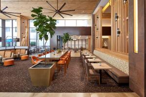 a restaurant with tables and chairs and a ceiling at Homewood Suites by Hilton San Diego Hotel Circle/SeaWorld Area in San Diego