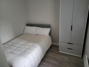 a small bedroom with a bed and a white cabinet at Mountain Stream House 