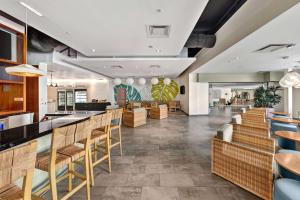 a restaurant with wooden chairs and a bar at Hotel MDR Marina del Rey- a DoubleTree by Hilton in Los Angeles