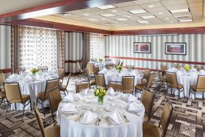 a banquet room with white tables and chairs at Courtyard Boston Natick in Natick