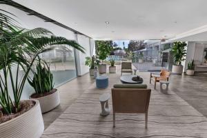 a lobby with potted plants and tables and chairs at Hotel MDR Marina del Rey- a DoubleTree by Hilton in Los Angeles