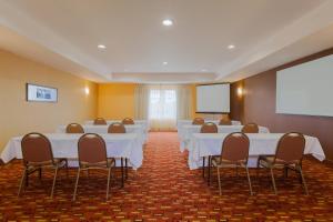 a conference room with white tables and chairs and a screen at Courtyard by Marriott Corpus Christi in Corpus Christi +11 photos