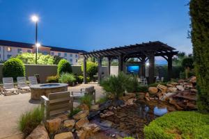 a patio with a pond and a gazebo at Courtyard Fort Worth West at Cityview in Fort Worth