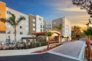 a rendering of the exterior of a hotel with palm trees at Homewood Suites by Hilton San Diego Mission Valley/Zoo in San Diego
