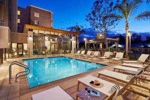 a swimming pool with lounge chairs and a hotel at Homewood Suites by Hilton San Diego Mission Valley/Zoo in San Diego