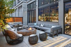 a patio with a fire pit with chairs and a table at Tapestry By Hilton The Fort Sutter Hotel Sacramento, Ca in Sacramento