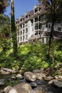 a resort with a stream in front of a building at The Inn at Saratoga, Tapestry Collection by Hilton in Saratoga