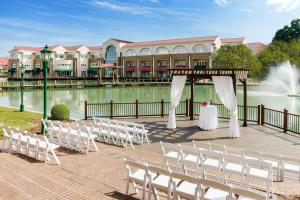 a wedding set up on a boardwalk next to the water at Hilton Charlotte University Place in Charlotte