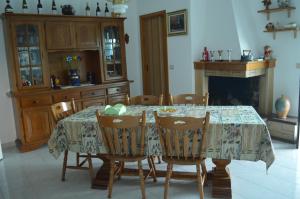 a dining room with a table with chairs and a fireplace at B&B Le Rose in Vignacastrisi