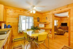a kitchen with a table and chairs in a room at Cozy Interlochen Cabin with Dock 1 Mi to Green Lake in Interlochen +18 photos