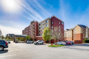 a parking lot with cars parked in front of buildings at Courtyard Cincinnati North at Union Centre in West Chester