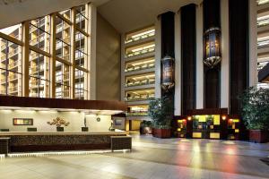 a lobby of a building with a waiting area at Hilton Bellevue in Bellevue