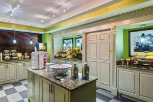 a large kitchen with green walls and white cabinets at Hampton Inn Atlanta Perimeter Center in Atlanta