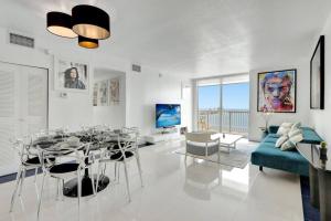 un salon avec une table et un canapé bleu dans l'établissement 3BR Penthouse with European Flair n Amazing Views, à Miami