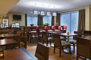 a dining room with tables and chairs in a restaurant at Hampton Inn Raleigh Cary in Cary