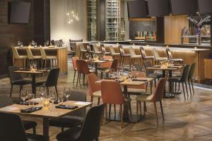 a restaurant with tables and chairs and a bar at DoubleTree by Hilton Colorado Springs in Colorado Springs