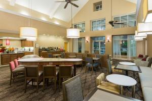 a restaurant with tables and chairs and a cafeteria at Homewood Suites by Hilton Houston-Clear Lake in Webster