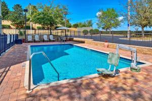 a swimming pool with blue water and two metal rails at Hampton Inn & Suites Clermont in Clermont