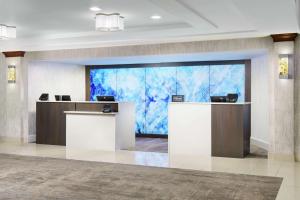 an office lobby with a large glass wall at DoubleTree by Hilton Orlando Airport Hotel in Orlando