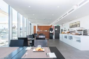 a kitchen with a table with a plate of food on it at Hotel Maroa Vigo in Vigo