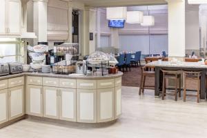 a kitchen with a counter with dishes on it at Hilton Garden Inn McAllen Airport in McAllen