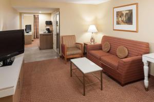 a living room with a couch and a tv at Hilton Garden Inn McAllen Airport in McAllen