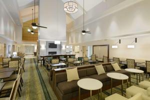 a lobby with a couch and tables and a bar at Homewood Suites Phoenix-Metro Center in Phoenix