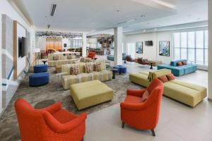 a lobby with couches and chairs and a library at Hilton Garden Inn Apopka City Center, Fl in Orlando