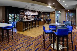 a bar with blue chairs and tables in a restaurant at Courtyard by Marriott Atlanta Buckhead in Atlanta
