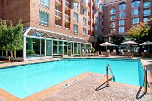 a large swimming pool in front of a building at Hilton Atlanta Perimeter Suites in Atlanta