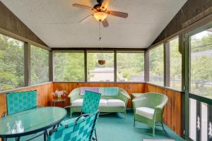 a screened in porch with a table and chairs at Pet-Friendly Queensbury Home with Screened Porch in Queensbury