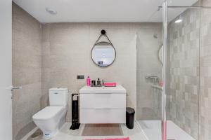 a bathroom with a white toilet and a shower at Yuli in Puerto de la Cruz +50 photos