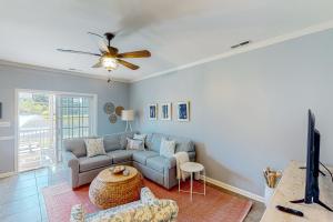 a living room with a couch and a ceiling fan at The Tides --- 19979 Sandy Bottom Cir, Unit #502 in Rehoboth Beach