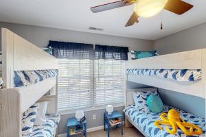 a bedroom with two bunk beds and a window at The Tides --- 19979 Sandy Bottom Cir, Unit #502 in Rehoboth Beach +13 photos