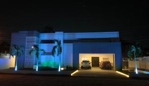 niebieski budynek z samochodem zaparkowanym w garażu w obiekcie MiCasa Stays w mieście Puerto Cortés