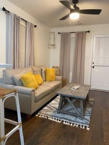 a living room with a couch and a table at Boho Hideway! in New Albany