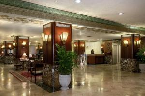 a lobby of a hotel with a plant in a pot at Hilton Cincinnati Netherland Plaza in Cincinnati